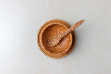 Wooden utensils on the kitchen table. Round wooden plates, a wooden spoon. The concept of serving, cooking, interior details. Top view