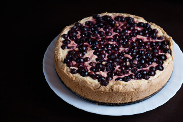 Berry pie cake from the cherries currants in a bowl of fresh steam a whole and slices of hot background blurred