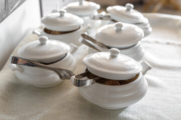 Sugar bowls with tongs filled with fruit sugar.