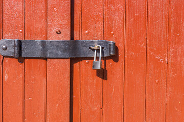 Padlock on the red wooden door.