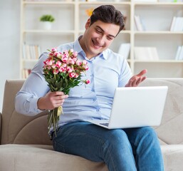 Young man making marriage proposal over internet laptop