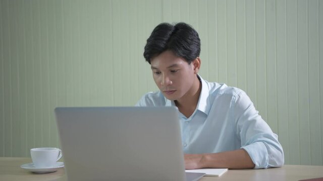 Business concept of 4k Resolution. An Asian man is delighted at his success at the office.