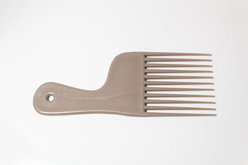 Brown hair comb over a white background