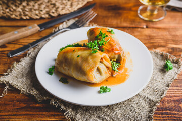 Two Cabbage Rolls Stuffed with Minced Beef on White Plate Garnished with Fresh Parsley