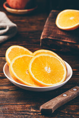 Slices of orange on white plate