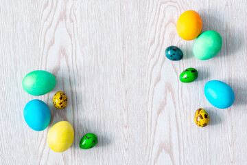 colorful easter eggs on wooden background with copy space flat lay, spring, easter concept frame