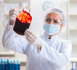 Woman doctor checking blood samples in lab