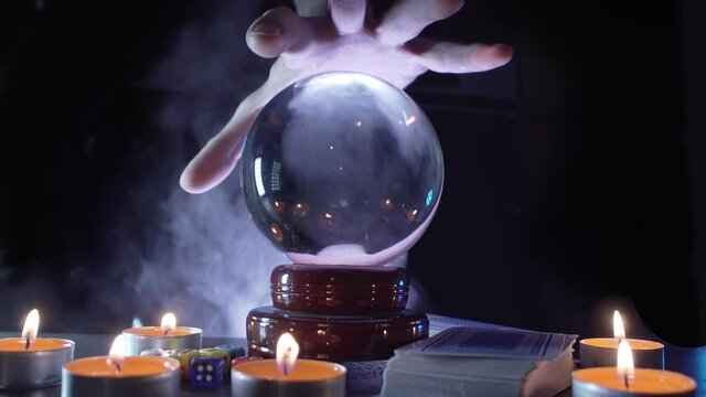 Magical fortuneteller's glass ball for predicting and telling the future. Smoke around.