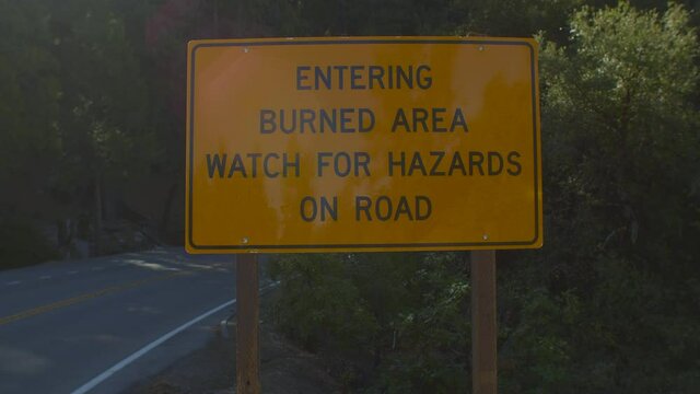 Panning Towards Burned Area Sign Along the Road in California