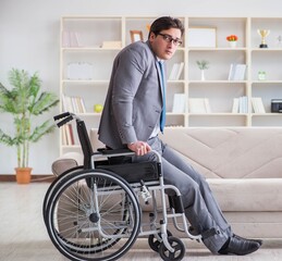 Dsabled businessman on wheelchair working home