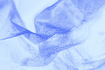 Pastel blue silk lace lingerie background, flowing fabric