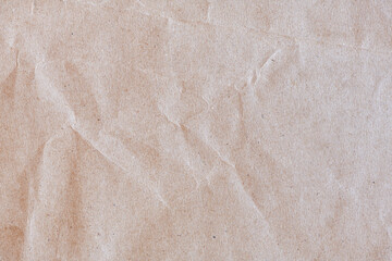 Wrinkled brown craft paper textured background. Rough paper for wrapping.