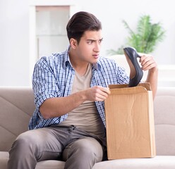 Man receiving wrong parcel with female woman shoes