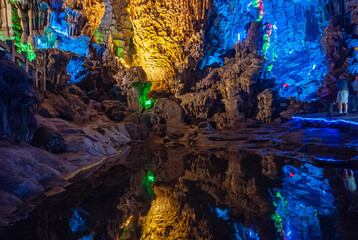 Guilin, China - May 11, 2010: Ludi Lu or Reed Flute Cave. blue lighted section of grotto with...