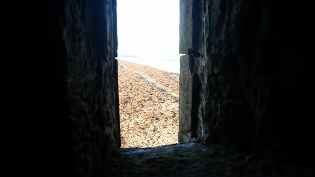 View through ancient stone castle window overlooking moorland highland countryside wilderness dolly right