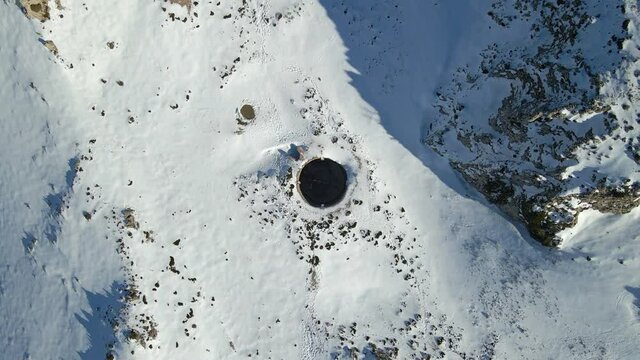 Aerial view of a well in the snowy mountains, Sierra de Serella, Alicante, Spain.