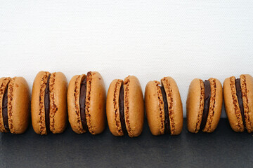 Chocolate macaron cookies filled with cocoa ganache cream