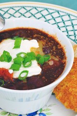 View of a bowl of vegetarian chili with cheese and cream
