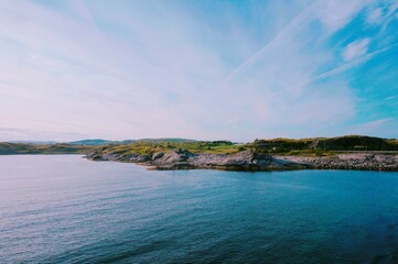 Obraz premium Rocky Coastline and Blue Sea under a Clear Sky