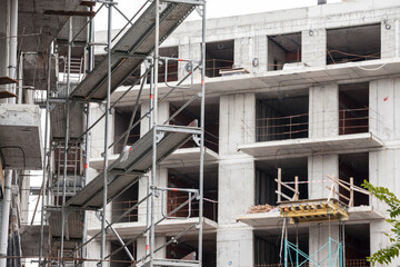 Selective blur on a Detail of a Scaffolding on a residential skyscraper construction site in Belgrade, Serbia, on a sunny afternoon, with concrete structures ready for use