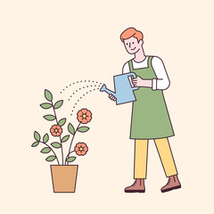 A man in an apron is holding a watering can and watering a flower pot. flat design style minimal vector illustration.