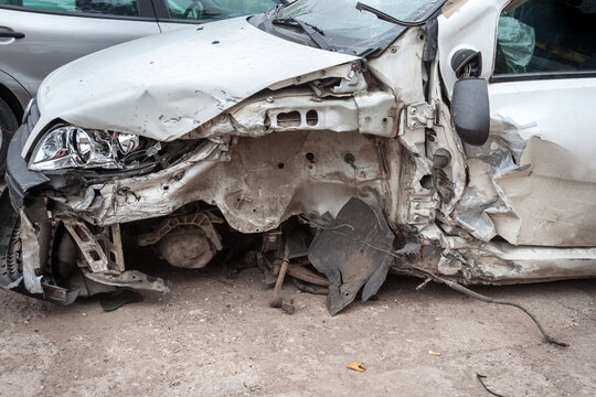 Picture of a damaged car, following a traffic accident, with a focus on a dented bodywork.