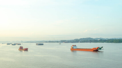 Commercial boat cruising Mahakam river, Samarinda in the morning. Traffic at Mahakam river. 