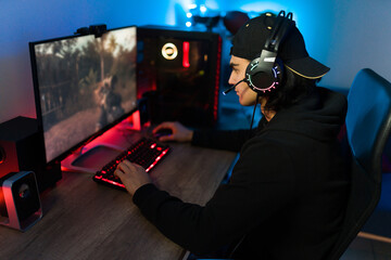 Latin man on a leisure day having fun with a gaming PC