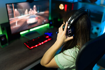Young woman adjusting her microphone to talk to an online player