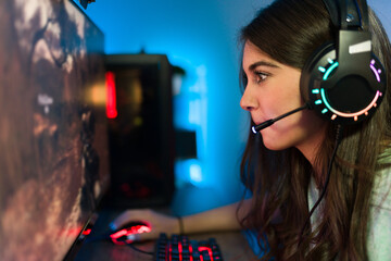 Beautiful female gamer focusing on winning a game © AntonioDiaz