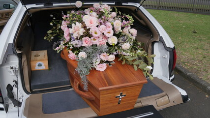 Fototapeta na wymiar closeup shot of a funeral casket in a hearse or chapel or burial at cemetery 