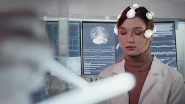 Working on brainwave scanning headset. Woman wearing sensors