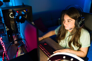 Excited woman gamer winning on a videogame while live streaming © AntonioDiaz