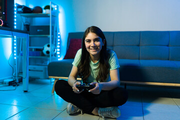 Happy woman gamer relaxing and gaming in her bedroom © AntonioDiaz