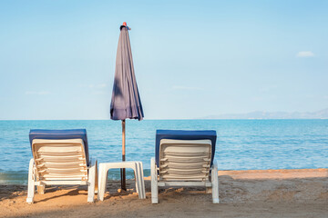 Two sun loungers on the beach