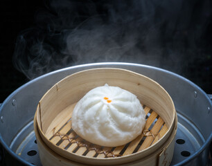 Steamed meat bun on hot steam pot, Hot steamed pork bun in bamboo steamer container.