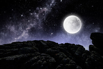 Fototapeta na wymiar Bright full moon over dark mountain
