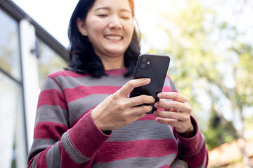 woman work using cell phone hand holding mobile texting message contact us.chatting,search internet...