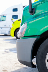 truck in the lot. Close-up of a green, yellow, white truck in a parking lot, side view.