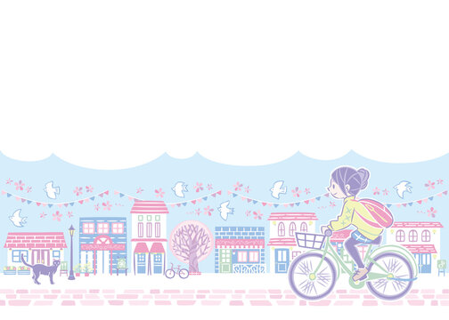春の桜の街並みで自転車に乗る女性
