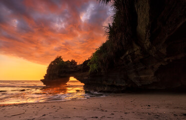 Dramatic Sunset color at Batu Bolong temple and Tanah Lot, Tabanan, Bali. beautiful view with the coral reef in low tide.
