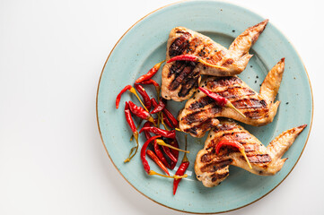 grilled chicken wings on a plate, restaurant serving, top view
