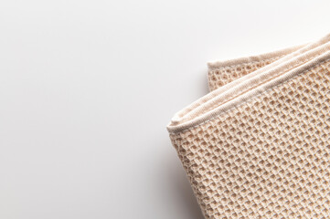 folded natural cotton towel on white background