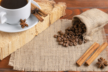 White cup of black coffee. bean coffee on burlap