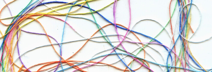 Multicolor tangled color needlecraft silk cord. Abstract color background, in white background	