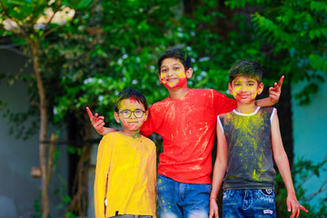 Fototapeta premium Cute indian little child’s group playing holi. Holi is colors festival in india