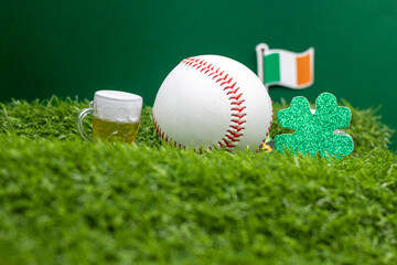 Baseball with beer and Shamrock clover for St. Patrick's Day on green grass