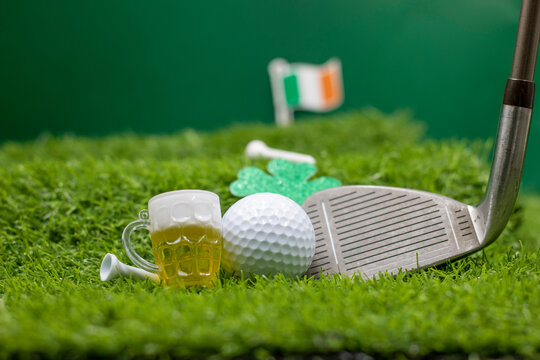 Golf for St. Patrick's Day with shamrock clover on green grass with golf club