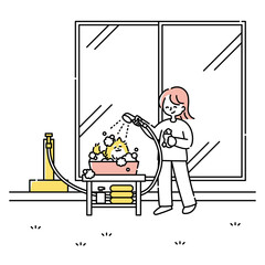 庭で犬をお風呂に入れる女性