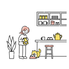 キッチンで犬にごはんをあげる女性